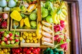 close up Miniature clay figurine Thailand`s floating market,Miniature boat carrying tropical fruit on wood background. Royalty Free Stock Photo