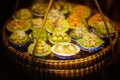 Close up Miniature clay figurine Thailand`s floating market,Miniature boat carrying tropical fruit on wood background. Royalty Free Stock Photo