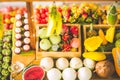 close up Miniature clay figurine Thailand`s floating market,Miniature boat carrying tropical fruit on wood background. Royalty Free Stock Photo