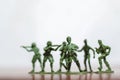 Close-up of miniature a group of plastic toys soldiers at war. Royalty Free Stock Photo