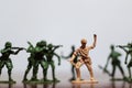 Close-up of miniature a group of plastic toys soldiers at war. Royalty Free Stock Photo
