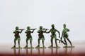 Close-up of miniature a group of plastic toys soldiers at war. Royalty Free Stock Photo