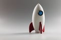 Miniature rocket toy stand on surface, rocketship as symbol for business project and startup