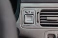 Close-up on mirror control buttons near the duct in the interior of an old Japanese car Royalty Free Stock Photo