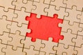 Close up of missing jigsaw puzzle piece with red space for text Royalty Free Stock Photo