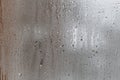 Close up for misted glass with droplets of water draining down. Dripping Condensation, Water Drops Background Rain drop