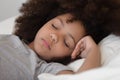 Close up mixed race cute peaceful child girl napping. Royalty Free Stock Photo