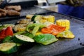 Close up of mixed vegetables grilled on outdoor grill.