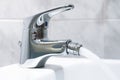 Close up of the mixer tap of a bidet with running water. The bidet was invented in France in the late 1700s