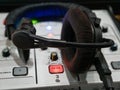 Close-up of a mixing console with a glowing on air button and headset at the workplace of a sports commentator