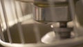 Close up mixing and kneading dough in automatic mixer on bakery kitchen