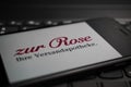 Close up of mobile phone screen on computer keyboard with logo lettering of german online mail-order pharmacy zur Rose Royalty Free Stock Photo