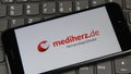 Close up of mobile phone screen on computer keyboard with logo lettering of online mail-order pharmacy  mediherz.de Royalty Free Stock Photo