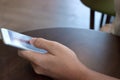 Close up mobile smart phone with blank screen on hands of unidentified people in coffee cafe. Royalty Free Stock Photo