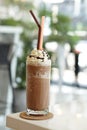 Close up of mocha coffee with whiped cream and nature bokeh background.