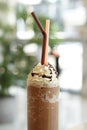 Close up of mocha coffee with whiped cream and nature bokeh background.