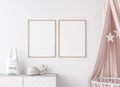 Close up for mock up wooden frame in Scandinavian kids bedroom with white wooden crib for newborn baby.
