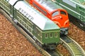 Close-up of model railway carriage on the rail tracks. Perfect model of the diesel locomotive. Train hobby model on the Royalty Free Stock Photo