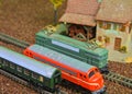 Close-up of model railway carriage on the rail tracks. Perfect model of the diesel locomotive. Train hobby model on the Royalty Free Stock Photo