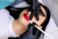 Close-up of the model`s lips which outline the contour with a white pencil before the permanent make-up procedure Royalty Free Stock Photo