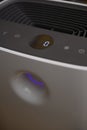 Close-up of modern air purifier control panel with digital display and purple air quality indicator ring Royalty Free Stock Photo