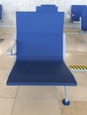 Close-up of modern Bench in the terminal of airport. Rows of empty blue seats. Contemporary lounge with seats in the airport, blue Royalty Free Stock Photo