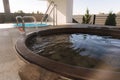 Close-up of modern big hot tub outdoor. Clear water in iron tube. Relaxation on holidays Royalty Free Stock Photo