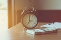 Close up of modern black color alarm clock at 7 o`clock on table in the morning Royalty Free Stock Photo