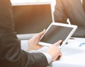 Close up of modern business-team using a tablet computer for work colleagues on the background Royalty Free Stock Photo