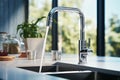 Close-up of modern chrome kitchen faucet with running water, acrylic stone countertop, stainless steel built-in sink Royalty Free Stock Photo