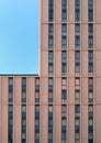 Close up of a modern concrete highrise concrete building with geometrical repeating windows with angular details and corner showin Royalty Free Stock Photo