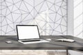 Close up of modern designer office interior with empty white mock up laptop screen, smartphone and book.