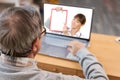 Close up of modern elderly man having online consultation with doctor Royalty Free Stock Photo