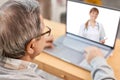 Close up of modern elderly man having online consultation with doctor Royalty Free Stock Photo