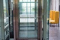 Lift with transparent glass doors in modern building Royalty Free Stock Photo