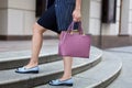 Close-up of a modern fashionable woman in shoes, standing on the street. Women& x27;s feet in blue shoes.