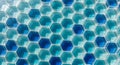 A close-up of a modern geometric pattern featuring hexagonal tiles in glossy blue, green, and white arranged in a repeating design Royalty Free Stock Photo