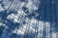 Close up of a modern glass office building. Reflection of the sky with clouds in the glass of the building Royalty Free Stock Photo