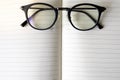 Close up modern glasses on blurred opened book with copy space Royalty Free Stock Photo