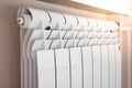 Close-up of modern home heating radiator under the window. Bimetal, aluminium radiator. Morning light Royalty Free Stock Photo