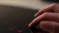 Close up of a modern induction stove control panel, household utensils. Concept. Female hand touching sensor panel to Royalty Free Stock Photo