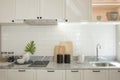 Modern kitchen island with built in sink and white countertops