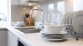 Close up of modern kitchen worktop with sink, dishwasher, and elegant tableware arrangement Royalty Free Stock Photo
