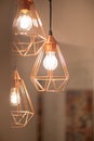 Close up of modern light lamp. Decor. Light bolbs are on. Orange metal frames Royalty Free Stock Photo