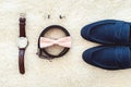 Close up of modern man accessories. Biege bowtie, leather shoes, belt, watch, cufflinks, money and wedding rings. Royalty Free Stock Photo