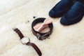 Close up of modern man accessories. Biege bowtie, leather shoes, belt, watch, cufflinks, money and wedding rings. Royalty Free Stock Photo