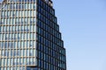 Close up of the modern new high Baltyk office building with many glass windows containing work