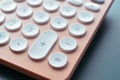 close up modern peach colour pastel calculator and white button on blue background Royalty Free Stock Photo