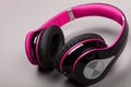 Close up modern pink headphones on gray table