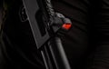 Close-up of a modern reflex sight mounted on a shotgun. Aiming device for marksmanship. Dark back